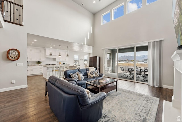 2118 N Snowy Crane Dr, Clinton, UT 84015 - living room with a high ceiling, dark wood-style flooring, baseboards, and recessed lighting