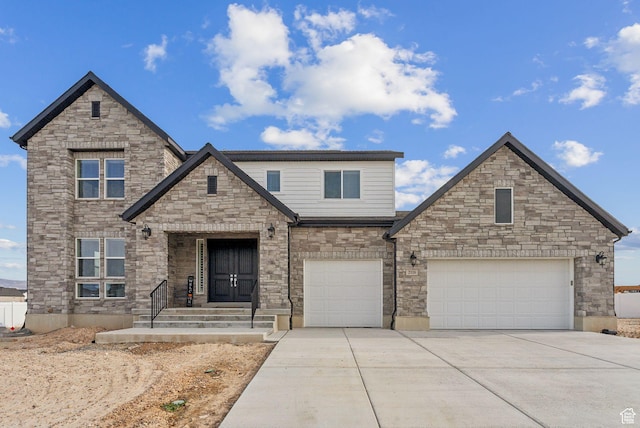 2118 N Snowy Crane Dr, Clinton, UT 84015 - view of front of house featuring driveway, stone siding, and an attached garage