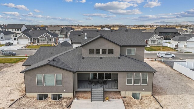 2118 N Snowy Crane Dr, Clinton, UT 84015 - rear view of property with roof with shingles, a residential view, stucco siding, and a mountain view