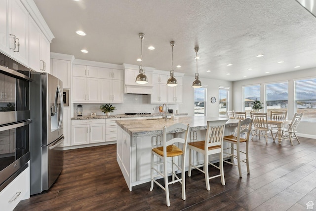 2118 N Snowy Crane Dr, Clinton, UT 84015 - kitchen with appliances with stainless steel finishes, dark wood-type flooring, white cabinetry, a sink, and recessed lighting