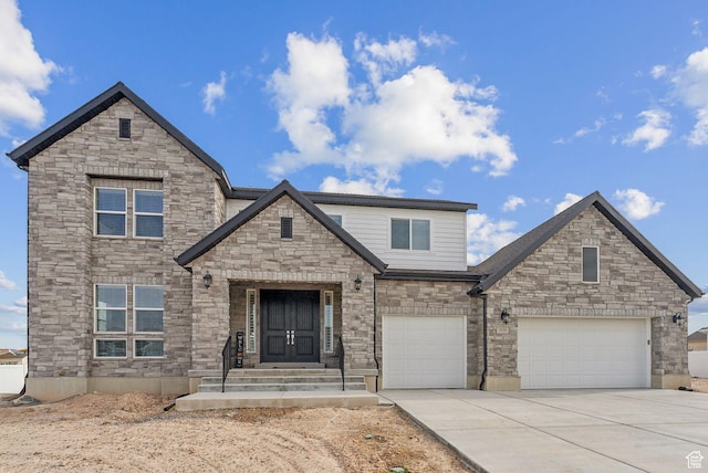 2118 N Snowy Crane Dr, Clinton, UT 84015 - view of front of property with driveway, stone siding, and an attached garage