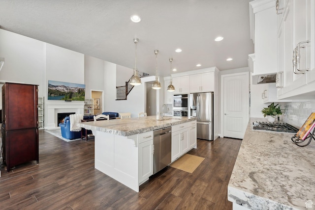2118 N Snowy Crane Dr, Clinton, UT 84015 - kitchen with stainless steel appliances, a sink, decorative backsplash, an island with sink, and open floor plan