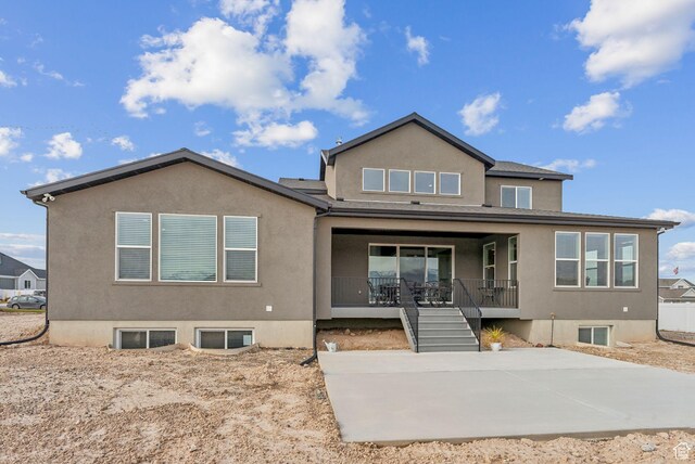2118 N Snowy Crane Dr, Clinton, UT 84015 - rear view of house featuring stucco siding, a porch, stairway, and a patio area