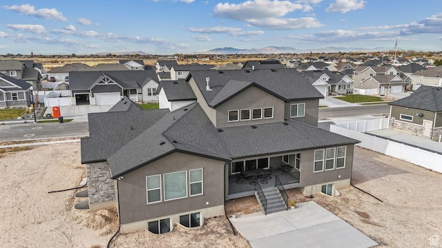2118 N Snowy Crane Dr, Clinton, UT 84015 - rear view of property with a residential view, roof with shingles, stucco siding, and a mountain view