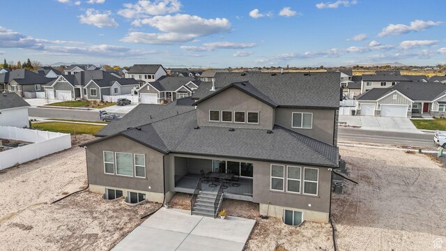 2118 N Snowy Crane Dr, Clinton, UT 84015 - rear view of house featuring a residential view, roof with shingles, and stucco siding
