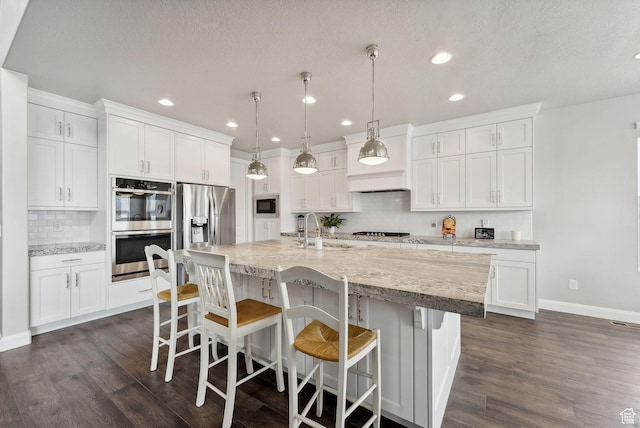 2118 N Snowy Crane Dr, Clinton, UT 84015 - kitchen featuring appliances with stainless steel finishes, a sink, decorative backsplash, white cabinets, and recessed lighting