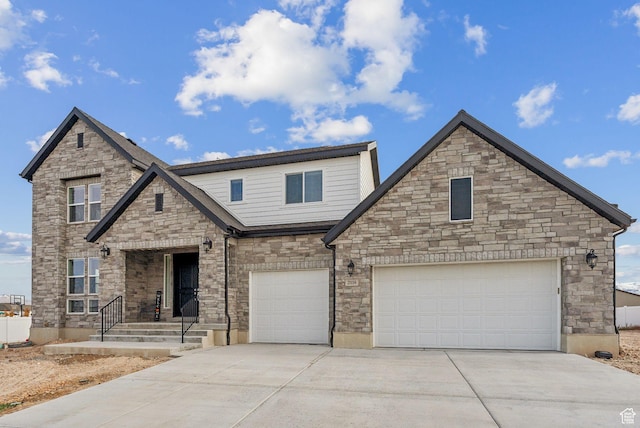 2118 N Snowy Crane Dr, Clinton, UT 84015 - view of front of property featuring driveway, stone siding, and an attached garage