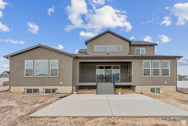 2118 N Snowy Crane Dr, Clinton, UT 84015 - rear view of property with stucco siding, a patio area, and covered porch