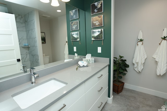 bathroom featuring tile patterned floors, vanity, and toilet