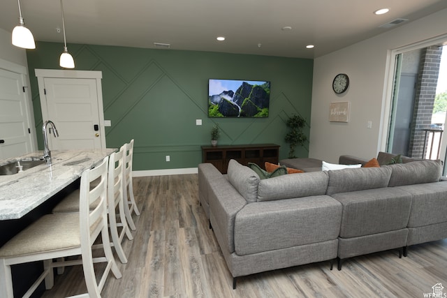 living room featuring hardwood / wood-style flooring and sink