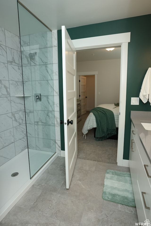 bathroom with vanity and tiled shower