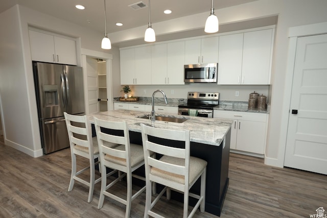553 S 100 W Unit 202, Richfield, UT 84701 - kitchen featuring stainless steel appliances, dark wood-type flooring, recessed lighting, white cabinets, and hanging light fixtures