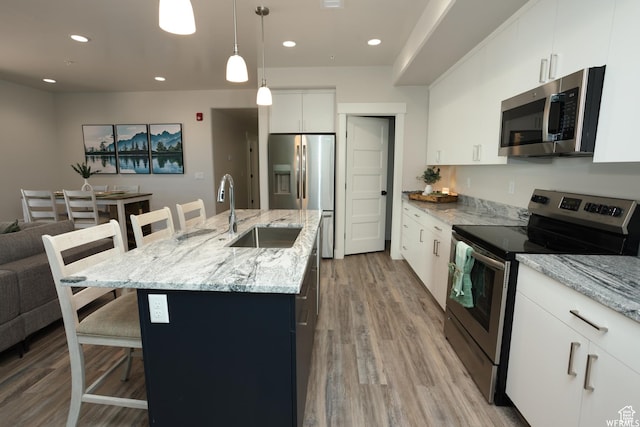 553 S 100 W Unit 202, Richfield, UT 84701 - kitchen featuring stainless steel appliances, a kitchen bar, light wood-style floors, recessed lighting, and pendant lighting