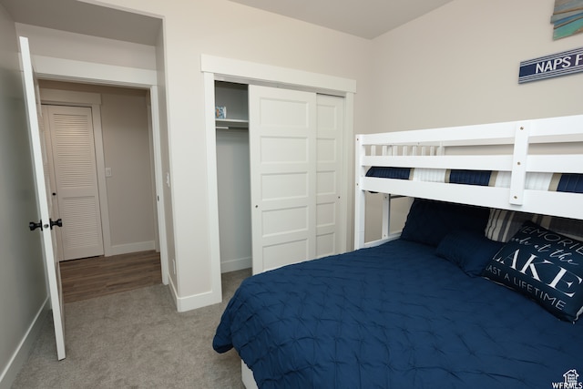 bedroom with carpet and a closet