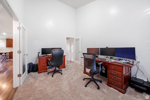 758 W Cedar View Dr, Saratoga Springs, UT 84045 - carpeted home office with french doors, a towering ceiling, and wood finished floors