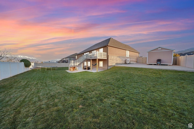 758 W Cedar View Dr, Saratoga Springs, UT 84045 - back of house at dusk with a fenced backyard, a patio, stairs, and a wooden deck