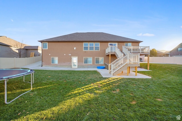 758 W Cedar View Dr, Saratoga Springs, UT 84045 - rear view of property featuring a trampoline, a fenced backyard, stucco siding, and a patio