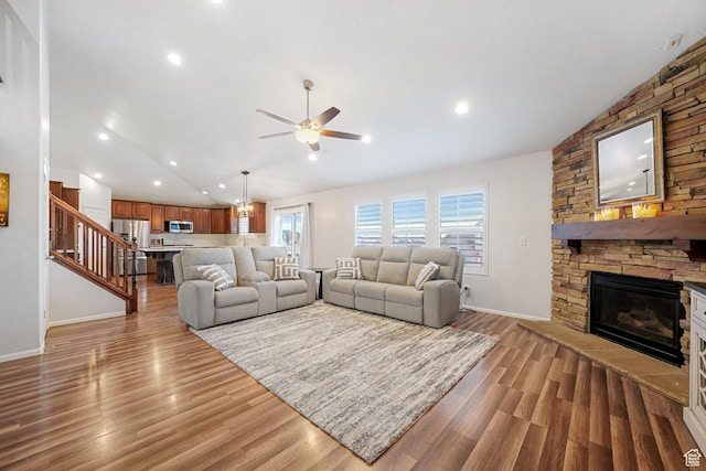 758 W Cedar View Dr, Saratoga Springs, UT 84045 - living room featuring lofted ceiling, a ceiling fan, a stone fireplace, wood finished floors, and stairs