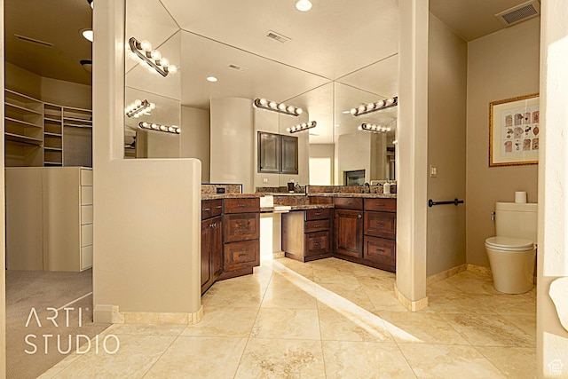 bathroom with vanity, toilet, and tile patterned flooring