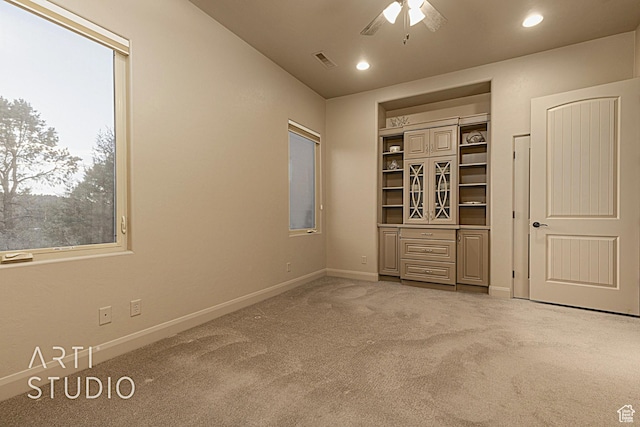 unfurnished bedroom featuring carpet floors and ceiling fan