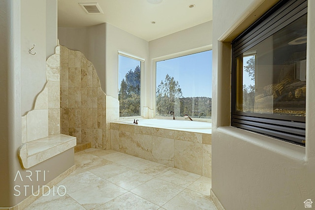 bathroom featuring tiled bath