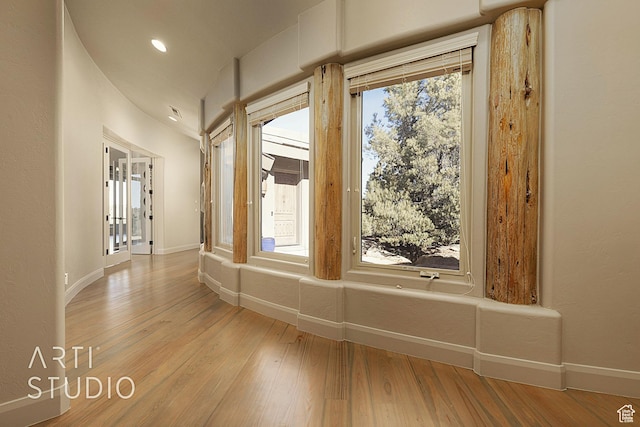 corridor with light hardwood / wood-style flooring