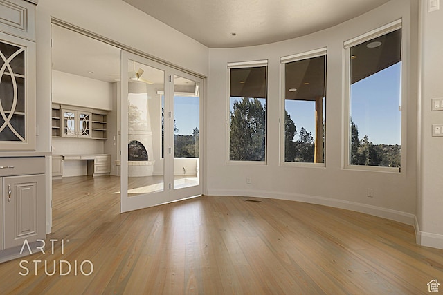 empty room featuring a healthy amount of sunlight and hardwood / wood-style floors
