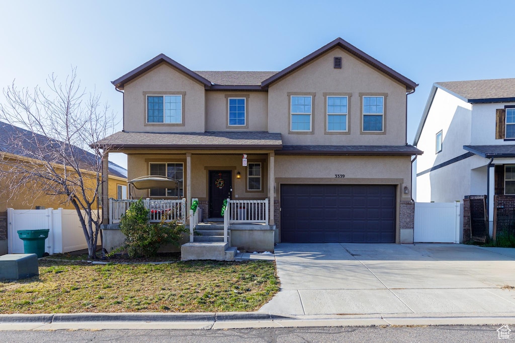 3339 N Falcon Way E, Layton, UT 84040 - view of front of home with a porch and a garage