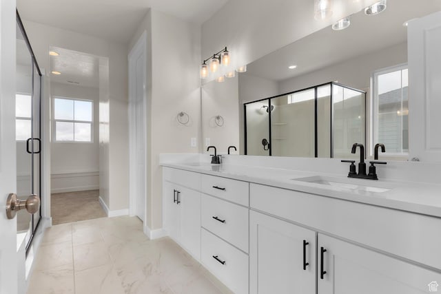 bathroom with vanity, a healthy amount of sunlight, and an enclosed shower