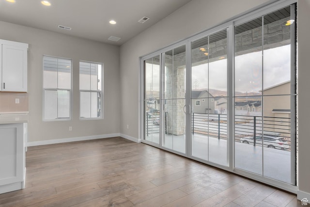 spare room with light hardwood / wood-style floors
