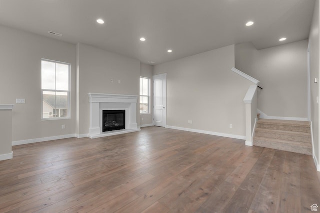 unfurnished living room featuring hardwood / wood-style flooring and plenty of natural light