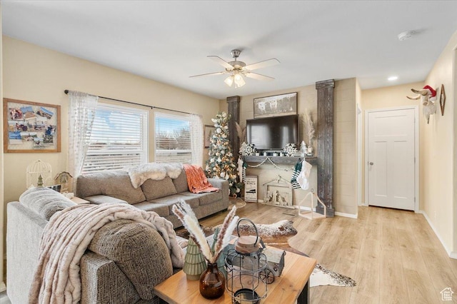 living room featuring light hardwood / wood-style flooring and ceiling fan