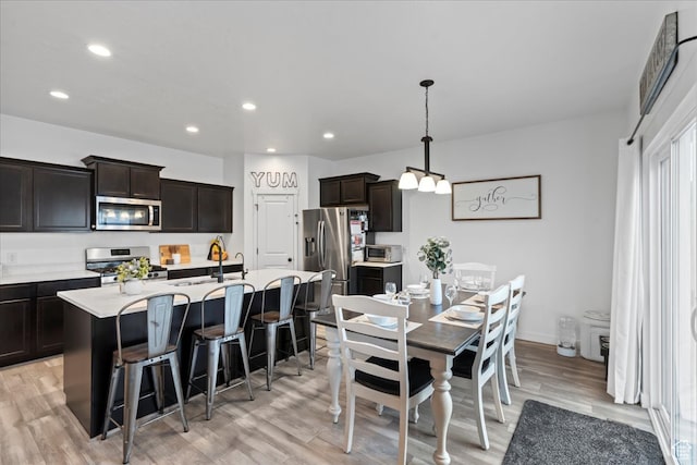 513 S Valkyries Ln, Saratoga Springs, UT 84045 - dining room featuring recessed lighting, a notable chandelier, light wood-type flooring, and baseboards