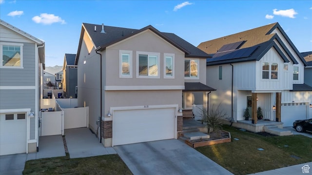 513 S Valkyries Ln, Saratoga Springs, UT 84045 - view of front of house featuring concrete driveway, stucco siding, a gate, a garage, and fence