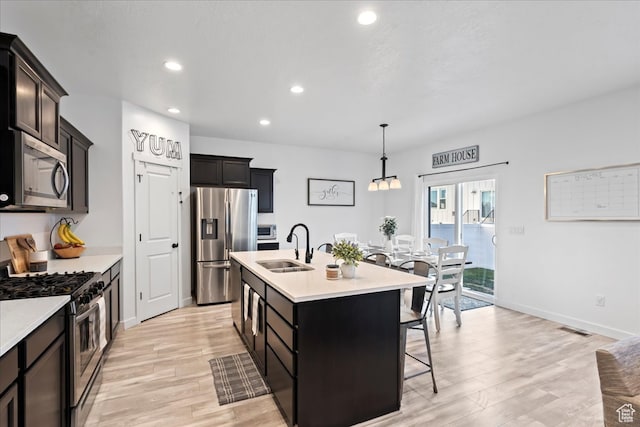 513 S Valkyries Ln, Saratoga Springs, UT 84045 - kitchen featuring recessed lighting, light wood-style flooring, light countertops, appliances with stainless steel finishes, and a sink