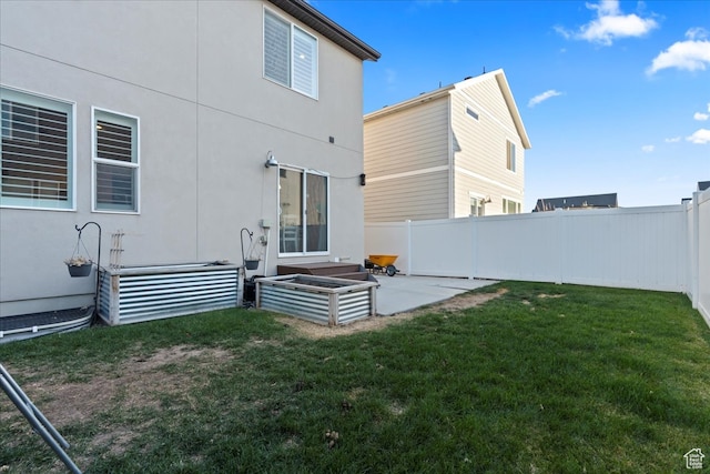 513 S Valkyries Ln, Saratoga Springs, UT 84045 - rear view of property with a patio, a fenced backyard, and a lawn