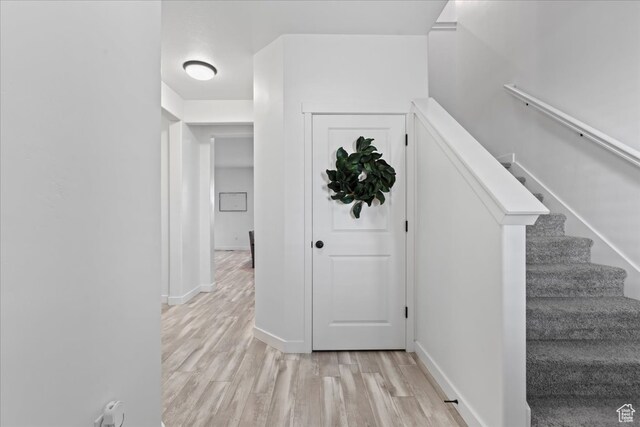 513 S Valkyries Ln, Saratoga Springs, UT 84045 - hallway with stairs, light wood finished floors, and baseboards