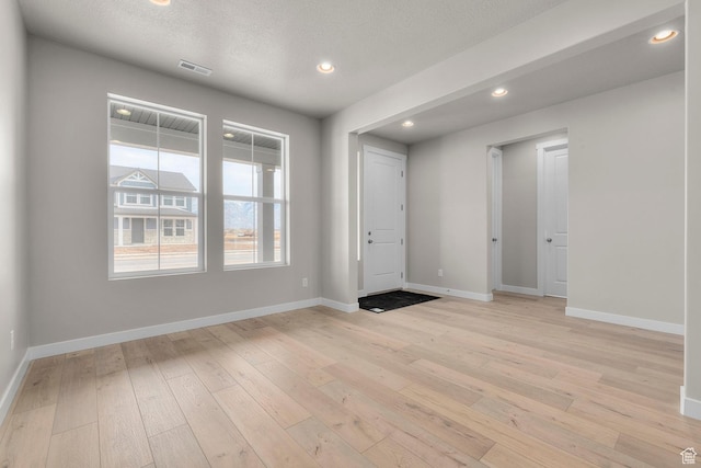 1839 S 2475 W, West Haven, UT 84401 - unfurnished room featuring a textured ceiling and light hardwood / wood-style floors