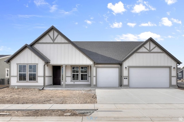 view of front facade with covered porch, cooling unit, and a garage
