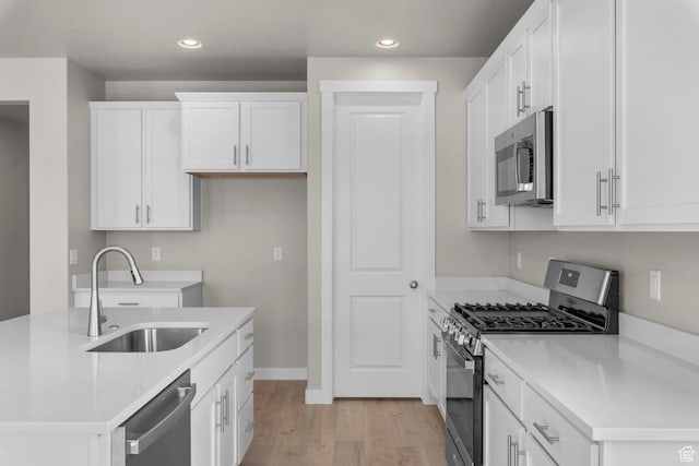 1839 S 2475 W, West Haven, UT 84401 - kitchen featuring white cabinets, stainless steel appliances, light hardwood / wood-style floors, and sink