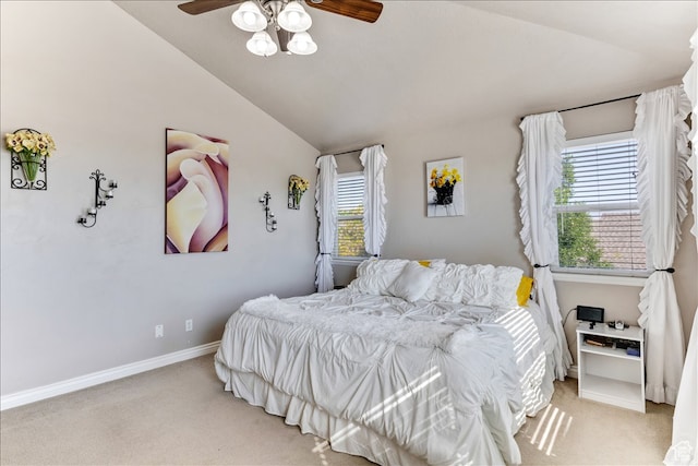 bedroom featuring baseboards, ceiling fan, light colored carpet, and vaulted ceiling