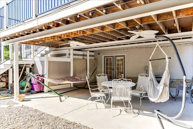 view of patio with stairway, ceiling fan, french doors, and outdoor dining space