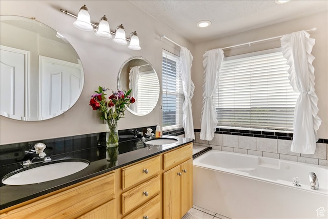 full bathroom with a garden tub, double vanity, a sink, and tile patterned flooring