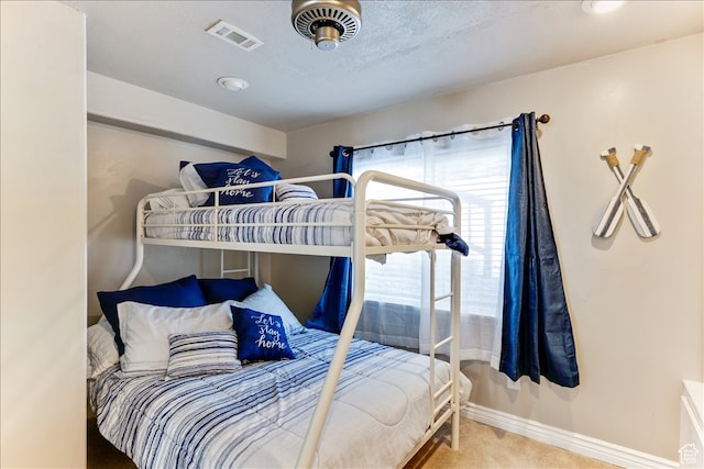 bedroom featuring visible vents, carpet floors, and baseboards