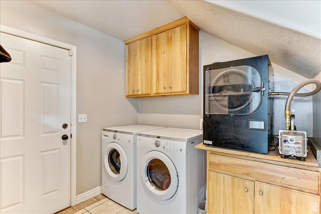 laundry area with light tile patterned flooring, separate washer and dryer, and cabinet space