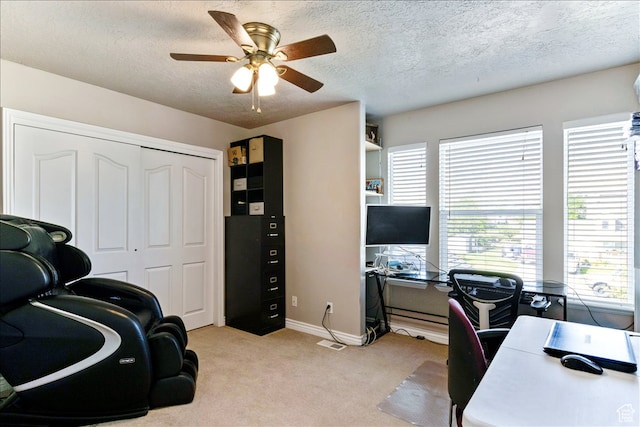 office with a ceiling fan, baseboards, light carpet, and a textured ceiling