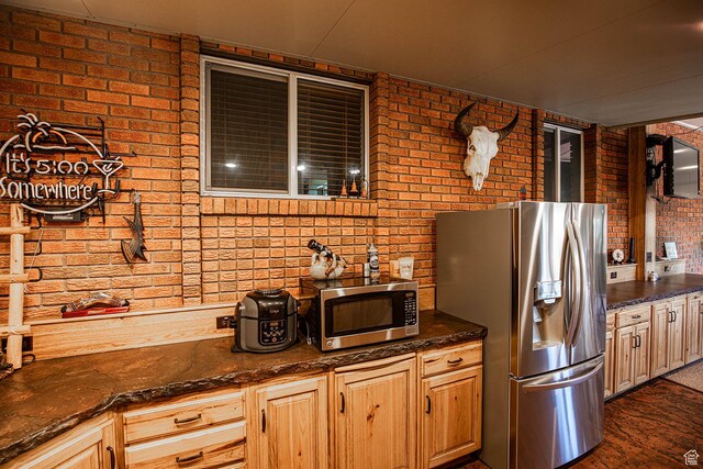 148 S Sunnybrook Dr, Salina, UT 84654 - kitchen featuring stainless steel appliances, brick wall, and dark stone counters