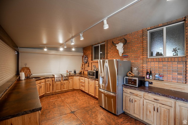 148 S Sunnybrook Dr, Salina, UT 84654 - kitchen featuring stainless steel appliances, brick wall, rail lighting, light brown cabinets, and tile patterned floors