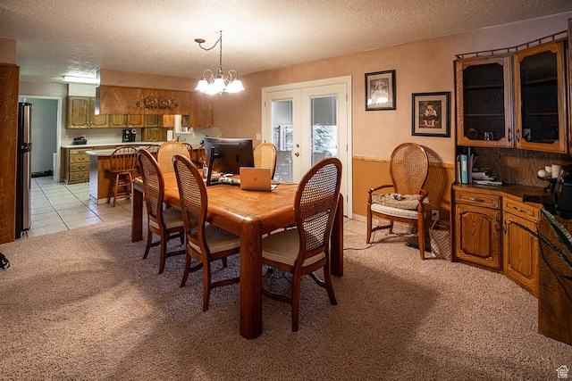 148 S Sunnybrook Dr, Salina, UT 84654 - dining space featuring light colored carpet, french doors, a textured ceiling, and a chandelier