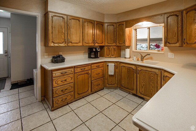 148 S Sunnybrook Dr, Salina, UT 84654 - kitchen with brown cabinets, a textured ceiling, light countertops, and light tile patterned flooring